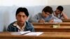 FILE - Students sit for their exam in what activists say is the only school in Hama not controlled by the Syrian regime, located in an area controlled by the Free Syrian Army, in Hama countryside, May 10, 2014. 