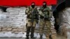 Armed pro-Russian men guard barricades in front of city hall in Slovyansk, eastern Ukraine, April 21, 2014.