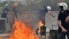 Riot police run from fire bombs thrown by protesters as they blame ruling AK Party government for mining disaster in western Turkey, Ankara, May 14, 2014.