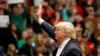 Republican presidential candidate, Donald Trump waves to the crowd during a rally at Radford University in Radford, Virginia, Feb. 29, 2016.