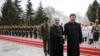 Chinese President Xi Jinping, center right, shakes hands with Iranian President Hassan Rouhani, as they pose for a photograph in an official arrival ceremony, at the Saadabad Palace in Tehran, Iran, Jan. 23, 2016. 