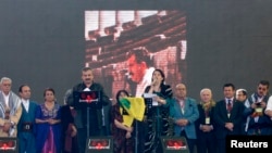 Pro-Kurdish politicians Sirri Sureyya Onder (3rd L) and Pervin Buldan (6th R) read the statement of jailed Kurdish rebel leader Abdullah Ocalan as they are flanked by other Kurdish politicians in the southeastern Turkish city of Diyarbakir, March 21, 2013
