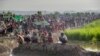 Newly arrived Rohingya Muslims who crossed over from Myanmar into Bangladesh rest in a field. After spending a night in the open, they wait for permission to proceed to refugee camps, Palong Khali, Bangladesh, Oct. 17, 2017. 