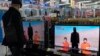 FILE - A man watches a news program about an Islamic State video purporting to show two Japanese captives at an electronics store in Tokyo, January 20, 2015. 