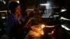 A local villager cooks dinner in Ta Thorng village, in Koh Kong province, some 140 kilometers (87 miles) west of Phnom Penh, file photo. 