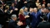 Turkey's Prime Minister Tayyip Erdogan greets his supporters as he arrives at a meeting at the Turkish parliament in Ankara, Feb. 18, 2014. 
