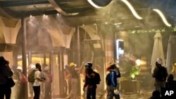 Protesters are engulfed in tear gas and sprayed by water canons at the entrance of the Divan Hotel, Istanbul, June 15, 2013.