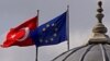 FILE - Flags of Turkey and the European Union are seen over the dome of a mosque in Istanbul, Turkey, Oct. 4, 2005. 