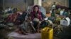 A 19-year-old woman and her children wait for their first hot meal in over two months at the Dosseye refugee camp in Chad. They arrived the previous day after fleeing violence in C.A.R.