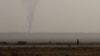 FILE - Smoke rises in Deir al-Zor, Syria Sept. 20, 2017. 