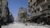 In this photo taken during a Syrian government-led media tour, buildings damaged during battles between Syrian troops and rebels stand along an empty street in Mleiha, about 10 kilometers (6 miles) southeast of downtown Damascus, Syria, Aug. 15, 2014. 