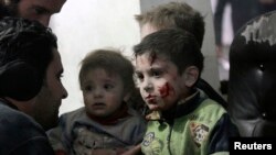 Injured children rest in a field hospital in the Duma neighborhood of Damascus, Jan. 21, 2015.