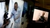 Video clips show China's jailed Nobel Peace laureate Liu Xiaobo lying on a bed receiving medical treatment at a hospital, left, and Liu saying wardens take good care of him, on a computer screens in Beijing, June 29, 2017.